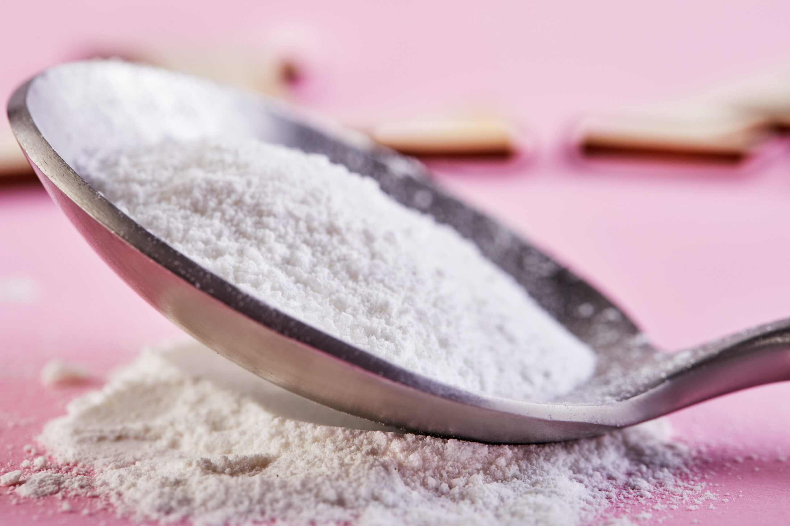 Collagen powder on a pink background Extra protein intake Natural cosmetic supplement for skin, bones, joints and intestines A plant or fish based